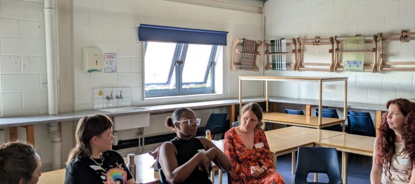 A group of women sitting together in a room