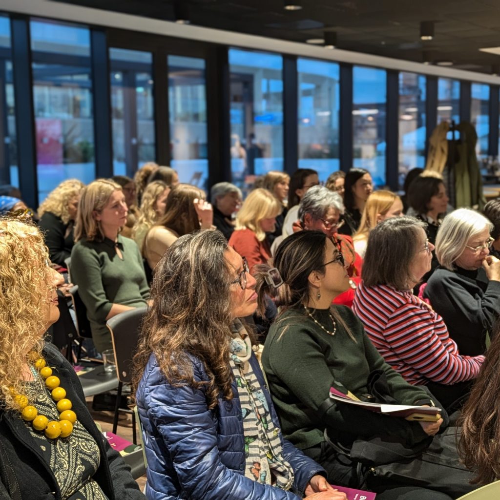 Women in the audience sitting and listening