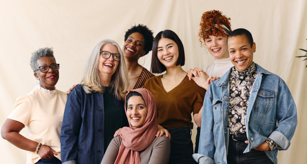 Portrait of mixed age range multi ethnic women smiling in celebration of International Women's Day